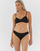 Front view of woman wearing black araks organic cotton isabella panty with black trim, and matching bralette.