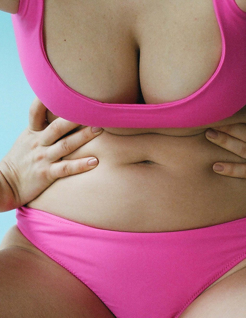 Woman wearing pink bikini top with matching swim bottoms