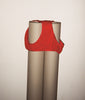 Red mid-rise panty draped on top of two rolls of paper. 