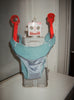 Toy robot displays turquoise panty with light blue silk front panel.