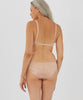 Back view of woman wearing beige panty and matching bralette.