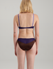 A woman wearing a blue and brown silk bra and panty by Araks