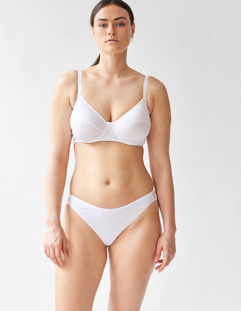 front of woman wearing white cotton underwire bra and matching panty by Araks