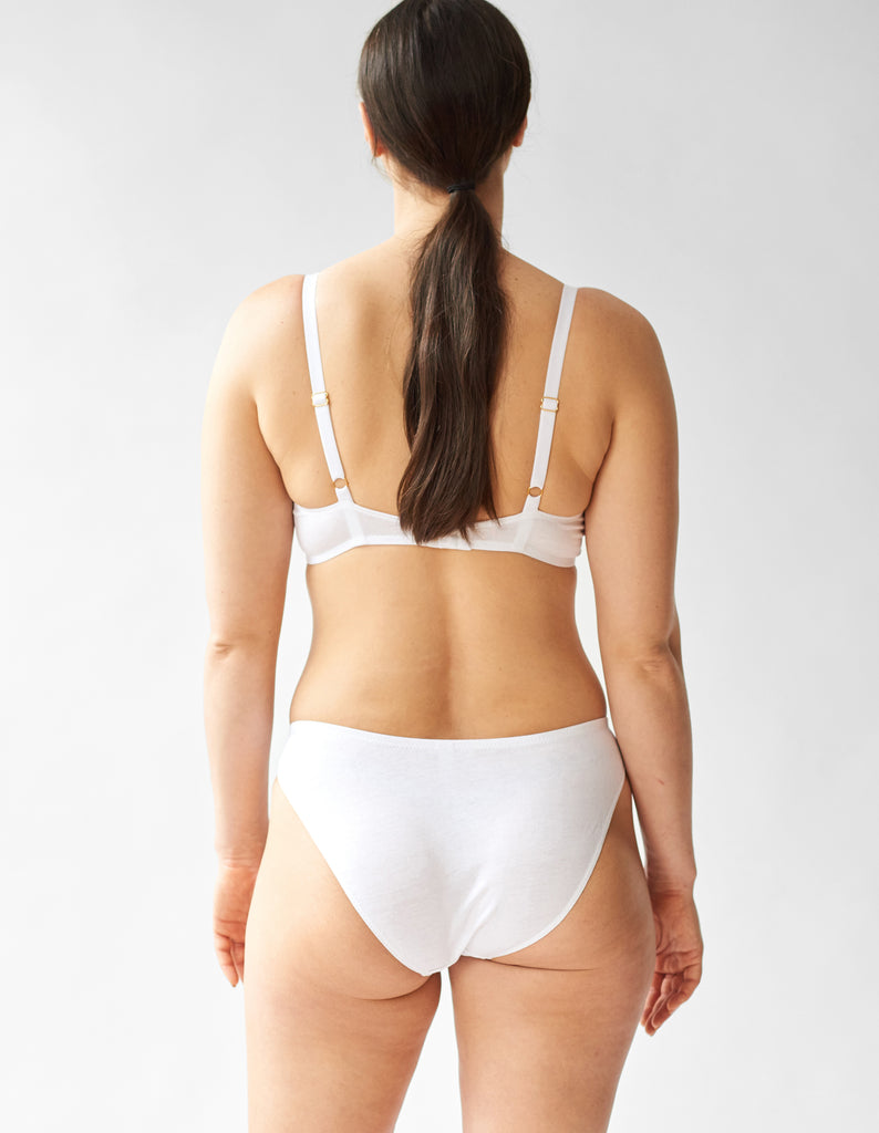 back of woman wearing white cotton underwire bra and matching panty by Araks