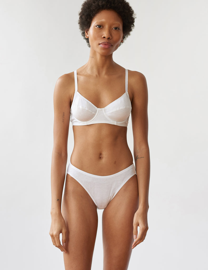 front of woman wearing white cotton underwire bra and matching panty by Araks
