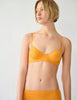 On model 3/4 image of orange underwire bra and panty
