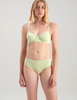 A woman wearing light green cotton underwire bra by and matching pantyby Araks