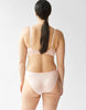 back view of woman wearing beige cotton bra and panty set