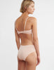 back of woman wearing beige cotton wireless bralette and matching hipster panty by Araks