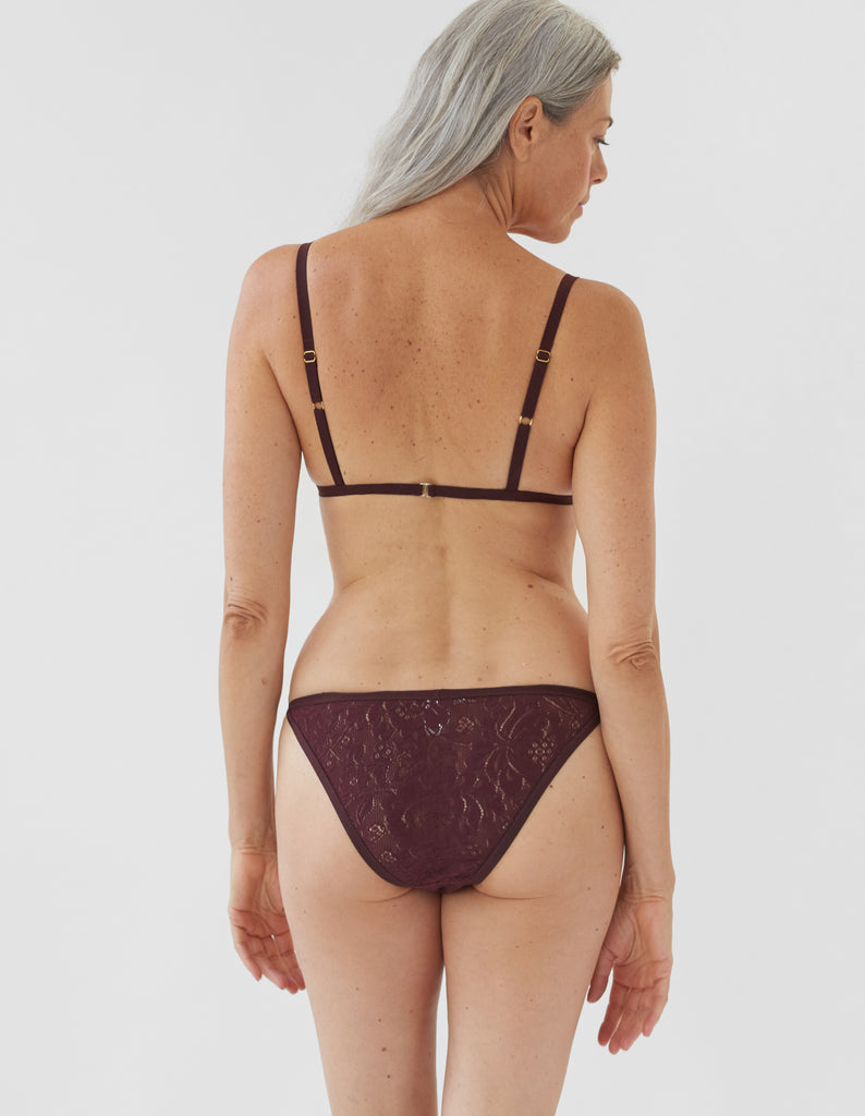 back of woman wearing dark red lace triangle bra and matching string panty