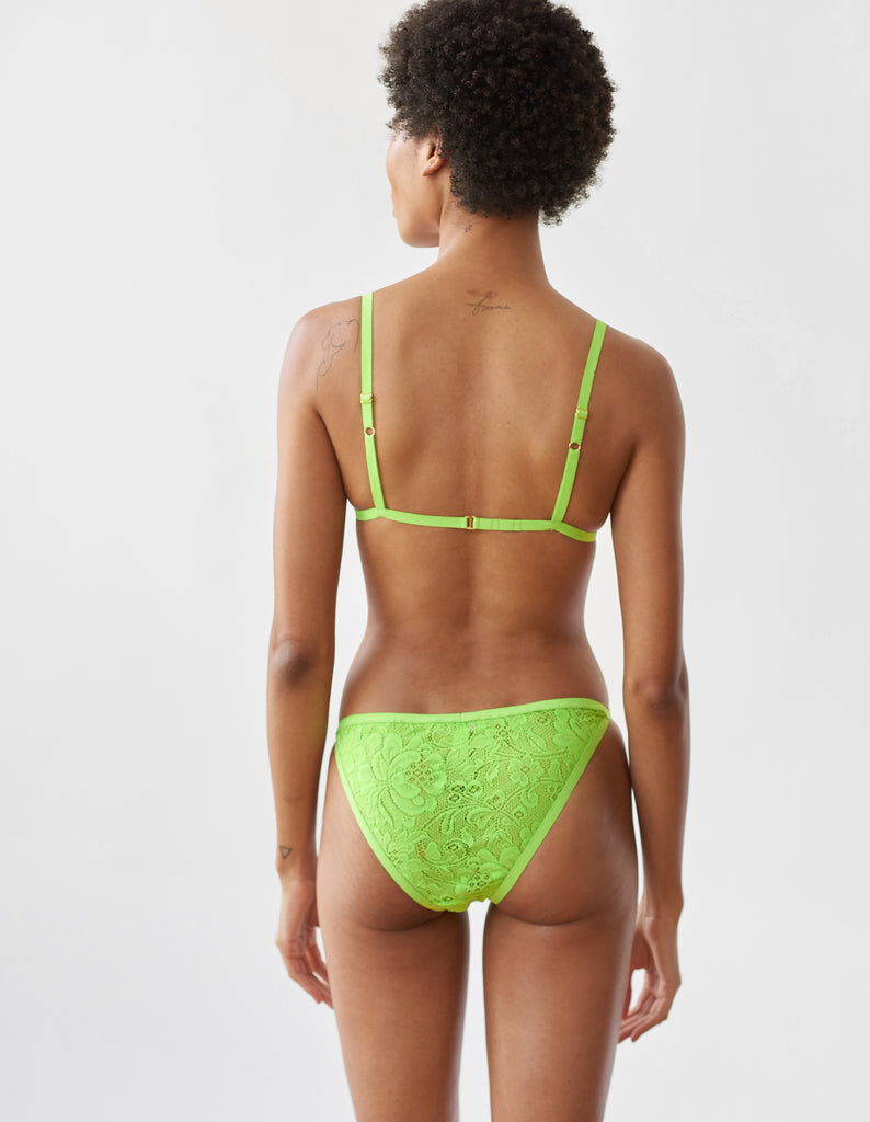 Woman wearing the green lace Bryce Bralette and Basja lace panty.