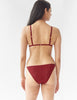 back of woman wearing red lace triangle bralette and matching panty by Araks