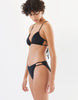 women in black string bikini top and matching bottom by Araks