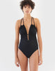 woman in black one piece swimsuit with deep neckline by Araks