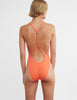 woman wearing orange one piece with knotted back  by Araks
