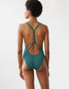 back of woman wearing green one piece with knotted back