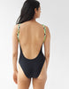 Back view of A woman wearing a black one piece swimsuit with braided straps.