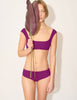 woman in purple bikini top and bottom