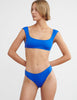 woman wearing blue bikini top and matching bottom by Araks