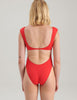 Woman in red one piece swimsuit backside
