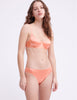 On model image of orange silk panty and underwire bra