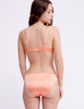 On model image of backside of orange silk panty and underwire bra