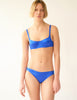 front view of woman in blue silk bra and panty