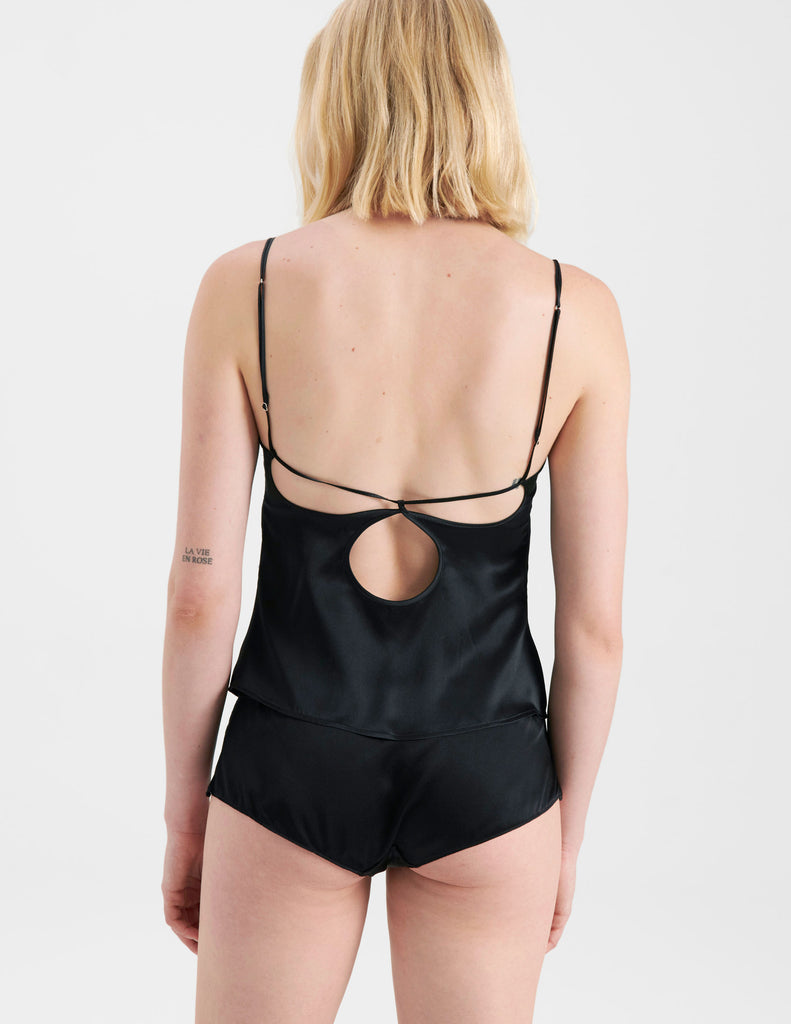 Back of woman in black silk Camisole with cutout details and matching panty