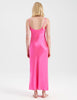 Back view of A woman wearing a long bright pink silk slip