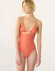 Woman in peach one piece swimsuit