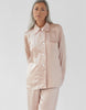 On model image 3/4 of silk pink/nude button up pajama with matching bottoms