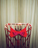 Red and magenta bralette hung on a chair.
