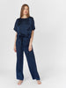 Woman wearing Navy silk boat neck sleep shirt with left breast pocket and matching silk pants