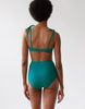 back of A woman wearing an underwire bikini top and matching high waisted bottom in teal.