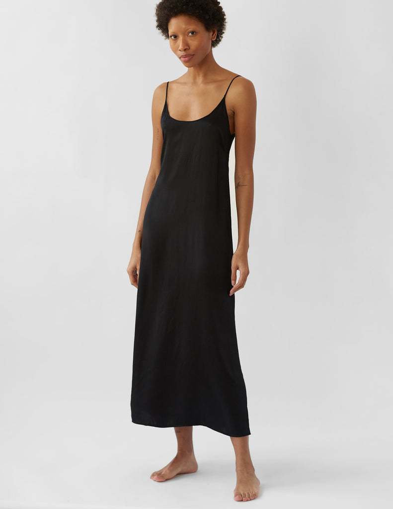 Woman in long black slip dress