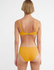 The Quinn Bikini in mustard yellow worn on a model and shown from the back.