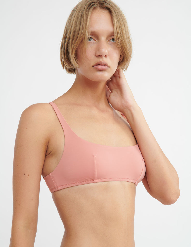 3/4  image of model wearing pink bikini top