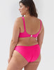 Woman wearing a hot pink high-waisted bikini bottom with side seams with matching scoop neck bikini top