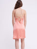 Back of Woman in peach silk slip with cut out details