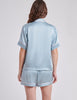 back view of blue pajama top and boxer on woman