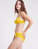 Side view of a woman wearing yellow bra and panty 