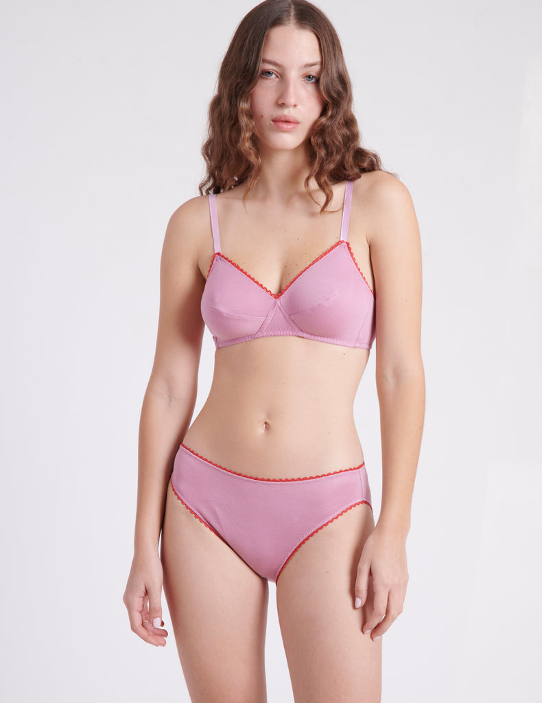 A woman wearing a pink cotton bra and panty.