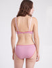 Back view of a woman wearing a pink cotton bra and panty.