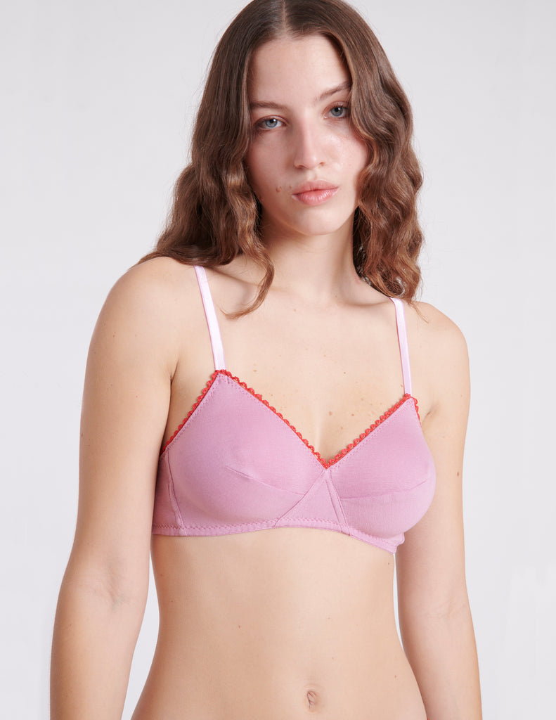 A woman wearing a pink cotton bra.