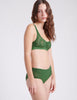 side view of woman in green lace bra and panty 