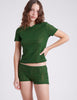 side shot of woman wearing green lace t shirt and short