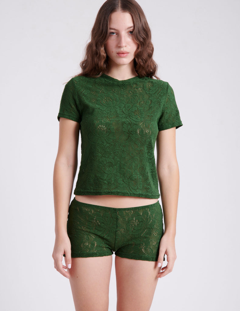 Front shot of woman wearing green lace t shirt and short