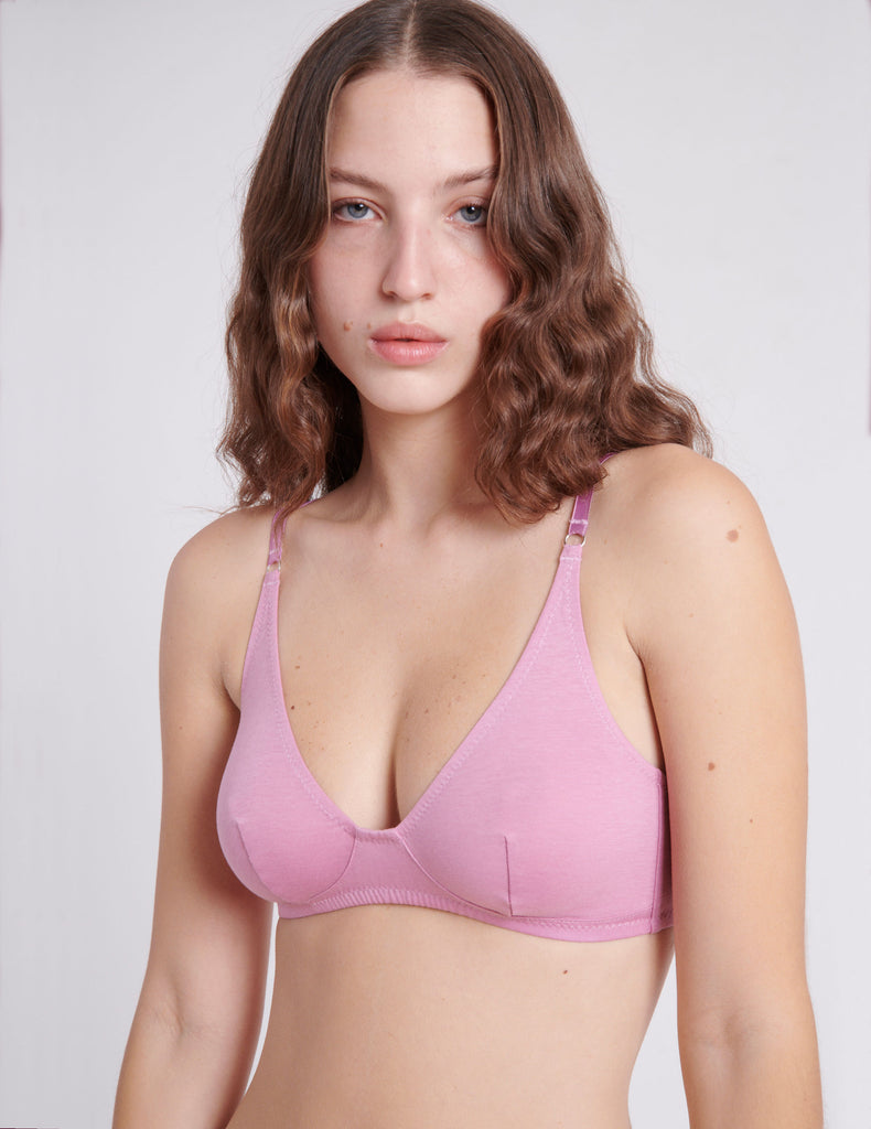 detail of woman in pink bra