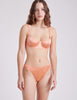 front view of woman in orange silk bra and panty