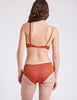 back view of woman in orange bra and pantt